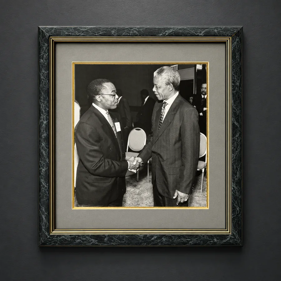 Framed photograph of Larry T. Brown shaking hands with Nelson Mandela